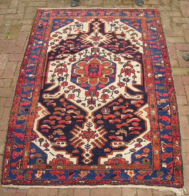 Bahktiari. 4 ft 5 inches by 6 ft 5 inches. Bold medallion rug with lots of ivory and great vivid color. Humans, birds, fish. Unusual green overcast on the sides appears to  ...