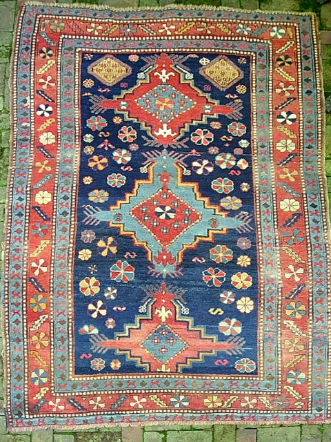 Kazak.  5 ft 2 inch x 8 ft-- Nice larger size. I think circa 1900 Period. Dynamic three medallion design and great colors. A bit of foundation spots-- mainly via brown  ...