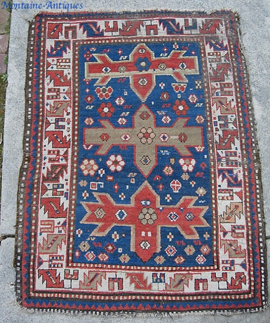 Old Kazak. 3 ft 5 inches by 4 ft 5 inches.  A restoration project. Photos tell the story.  $15 to ship in the us.       