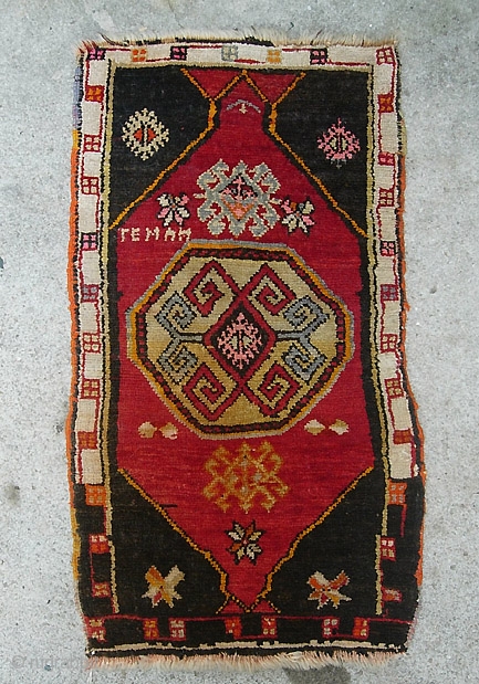 Yastik. 21 x 37 inches. A bold little rug with mystical design and some sort of script in the design, some synthetic colors.  $15 shipping in us.     