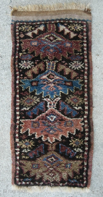 Kurdish. 13 inches by 27 inches. Real unique piece and may have been a bag or pillow cover. Aubergine weft with considerable fading where exposed. Great condition w/ extremely thick lustrous pile.  ...