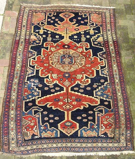 Old Persian. 4 ft 7 x 7 ft 1 inches. Decorative old rug with sensational colors. Dated in several places and looks like they were aiming to say 1300. That would put  ...