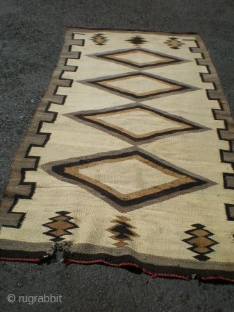 As found: A 1920's to 1930's Navajo rug, measuring 44"x91" (3'8"x7'7"), needs some reweaving on one end in three places, otherwise, pretty sound rug.  I like it's simplicity and large size  ...