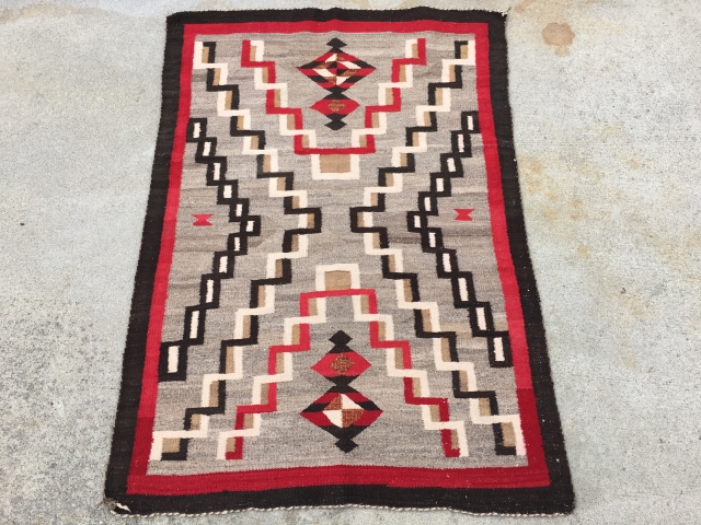 As found: A nice vintage mid century Navajo rug measuring 3'2" wide at one end, and 3'4" at the other end, and 4'8" long.  In pretty good shape except for a  ...