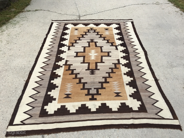 Very early 20th century large Navajo measuring 5’10”x8’6”, has a few holes and needs some other touch ups.               