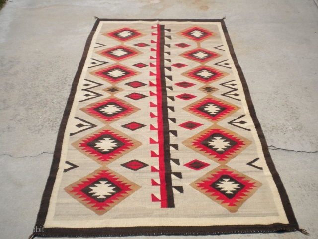 Rug Curator's find as found: A 1930's to 1940's Navajo rug measuring 51"x 90" in very good condition.  Thanks for looking.           