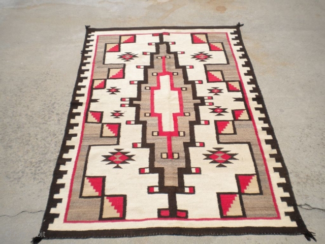 Rug Curator's find as found: A 1940's to 1950's (perhaps older) Navajo rug measuring 48"x 70" in very good condition.  Thanks for looking.         