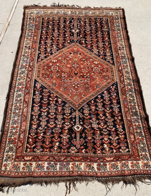 1920’s-30’s southern Iranian tribal rug (Bavanat) that’s been cut and shut at the two small white pendants flanking the medallion. Rug measures 5’x 7’10”.         