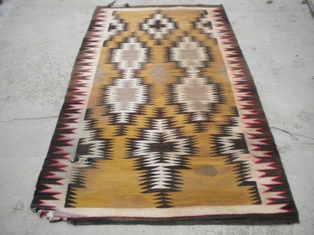 As found: An early 20th century Navajo rug measuring 4'5"x 8'3" with problems that you can see in the pictures.  I have removed the circular stain in the rug since posting  ...