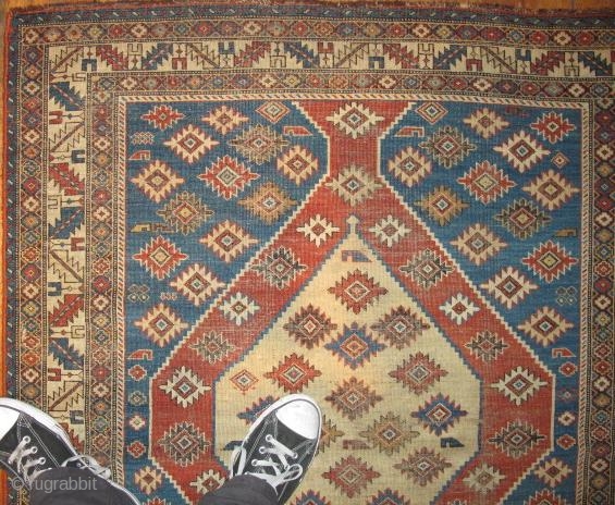 sweet little south Caucasian rug, good colors and some eccentric elements. damage to sides and bottom.                 