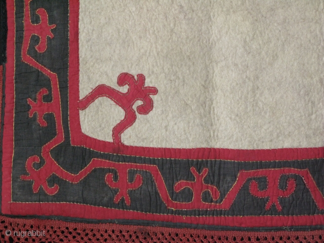 Kyrgyz Ceremonial camel or horse saddle cover. red dyed cotton fabric cut and sewn on felt with metallic yarn. velvet edging with wool madder dyed braided tassels. cotton printed backing. Size:   ...