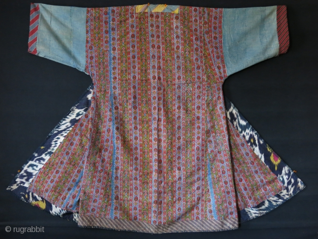 Tajikistan soft Shoi Ikat Chapan. Lined with printed Russian cotton and faced adras ikat. Indigo dyed lining inside of arms. A small pale stain on back side. Circa 1900 or earlier size:  ...