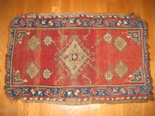 19th C. Yastik with great natural dye colors. Corners frayed and missing several rows on ends. Medium to low pile. Size 2'8" X 1'10".         