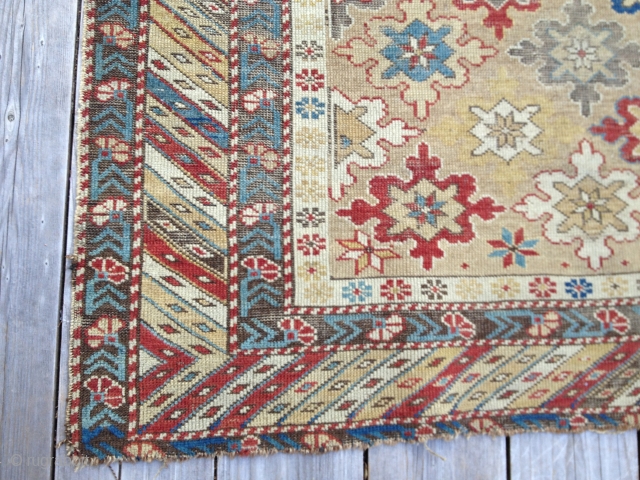 Early Shirvan snowflake design rug, ca 1870. Good natural colors, very low evenly worn pile. Exceptional palette reflecting good age. Missing outer borders on both ends. Yellow field and good variety of  ...