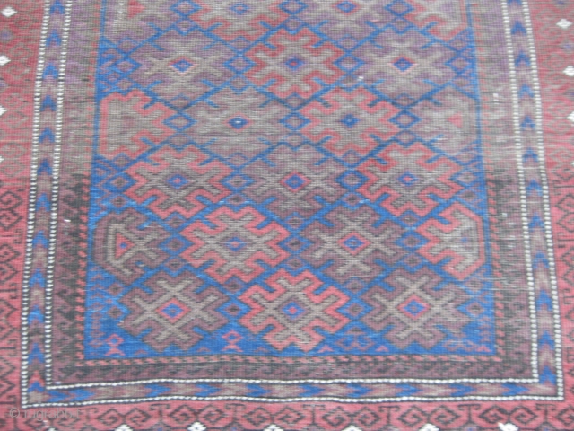 Late 19th C. Balouch rug. Nice colors including a great electric blue. Overall
low pile with wear as shown. Retaining almost all of kilim ends and all original selvedges. Size 65X32in/165X81cm. Washed. Price  ...