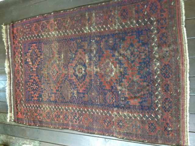 19th C. Baluch Main Carpet, 79"X48"/201X122cm. All natural dyes. Dark palette. Thin, soft floppy handle. Very evenly worn but still makes a statement with a good variety of design symbols. Retains part  ...