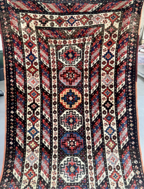 Offered here is an antique Caucasian long rug dating to the 19th century, measuring 325x125cm / 10,7ft by 4,1ft. The composition is centered around a vertical column of classic, stepped Memling guls, ...