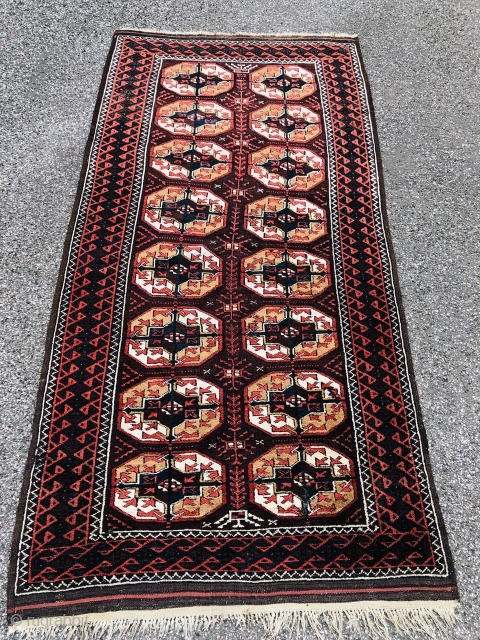 Antique Turkmen inspired Baluch rug with "Tekke Gul" design. Size: ca. 210x105cm / 7ft by 3'5''ft good overall condition, little old moth damage.          