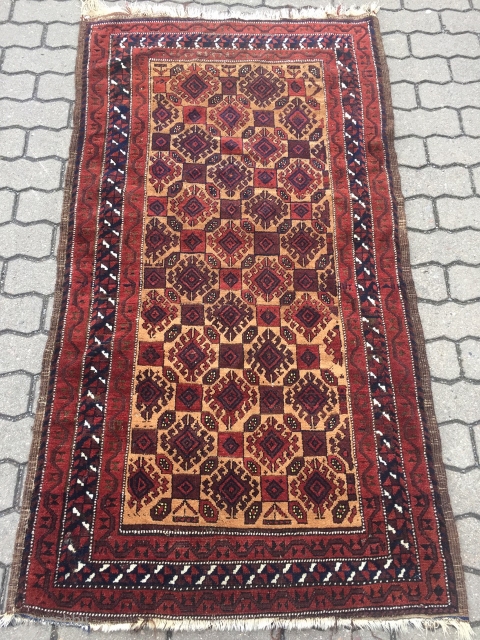 A very nice antique camel ground Baluch rug with saturated colors, shiny wool and a very well executed hooked design. The size is circa 170x90cm / 5'6''ft x 3ft    