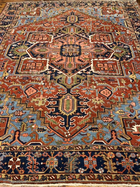 A highly decorative antique Persian Heriz carpet. Beautiful blue corners, size: ca. 345x290cm / 11’3ft by 9’5ft some localized wear.             