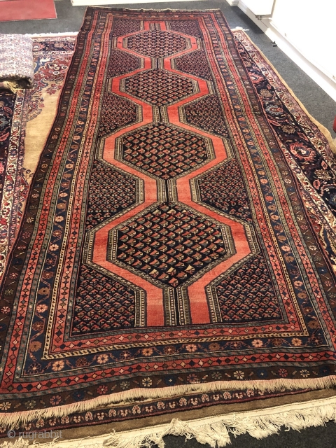 Antique Northwest Persian village rug from the Meshkin area. A perfect interaction between the pole medallion and the field design seperated by a brick red plane field. Size: ca. 405x155cm / 13'3''ft  ...