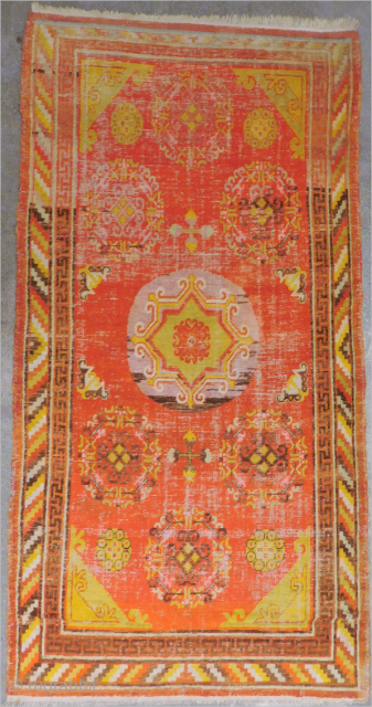 This antique hand-knotted Khotan rug is a stunning piece of Asian culture from the early 20th century. Measuring 4'1"x 7'10", it features a geometric pattern in multicolor wool, with a pile height  ...