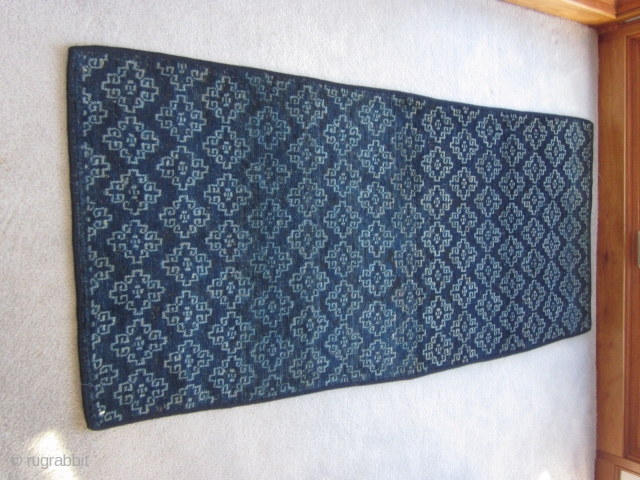 Tibetan Khaden, overall design of cloudbands forming ?guls, light and dark indigo, 30 by 67 inches, possible small repair in field as seen in shots. c.1900 Applied blue edging on all sides. 