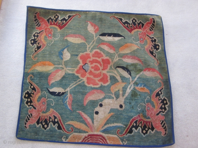 Tibetan mat with four gaily colored bats and a central lotus on an unusual and attractive green ground c.1920-30              