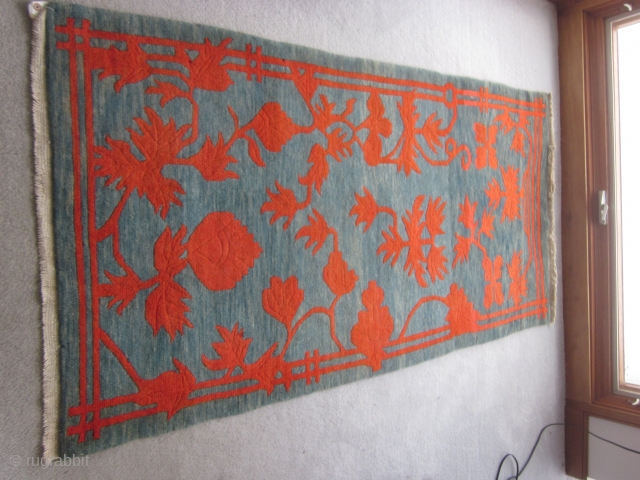 Tibetan khaden, mid-2othC,  35 by 69 inches, large red flowers (?)on exquisitely abrashed greenish-blue ground                 