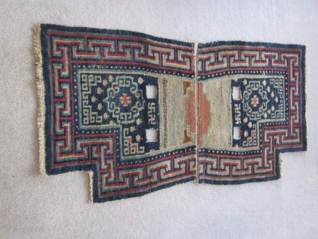 Tibetan : Vintage notched saddle bottom rug, 2" by 3'8", before 1900. Some re-piling around one cinch strap.               