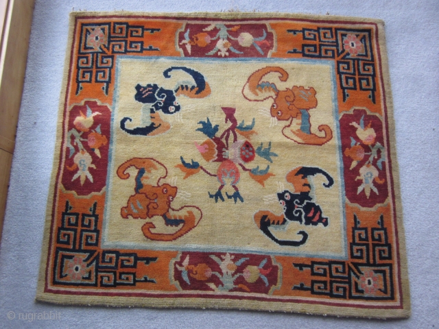 Tibetan mat, abt 3 by 3 ft, c.1930 Sinicized design with four hungry bats ready to feast on the three fruits            