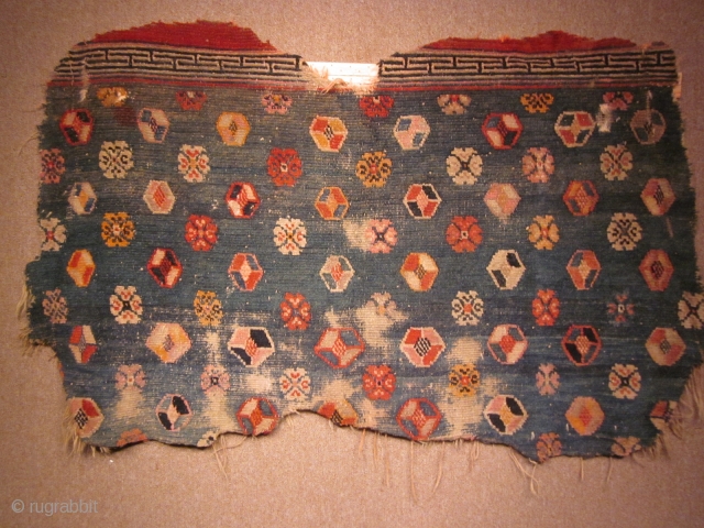 Tibetan horse cover, large fragment on green ground with scattered abstract flowers. Thickly woven. Early 20th C?                