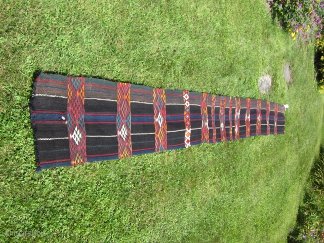 Beduin: Narrow kilim probably made in Jordan on a back strap loom c.1950. Rich colors include some hot dyes. Size: 19 by 162 inches. See last shot for small hole, the only  ...