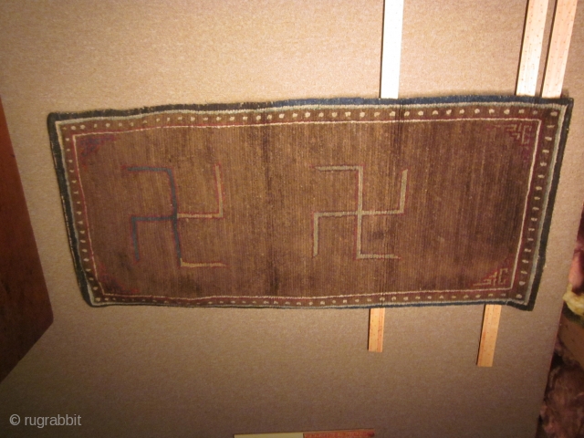 Tibetan, CORRECTION) Two large swastikas on brown field with small corner frets; exhibited at 1998 ACOR Conf., Denver: 27 by 62 inches, post-1900          