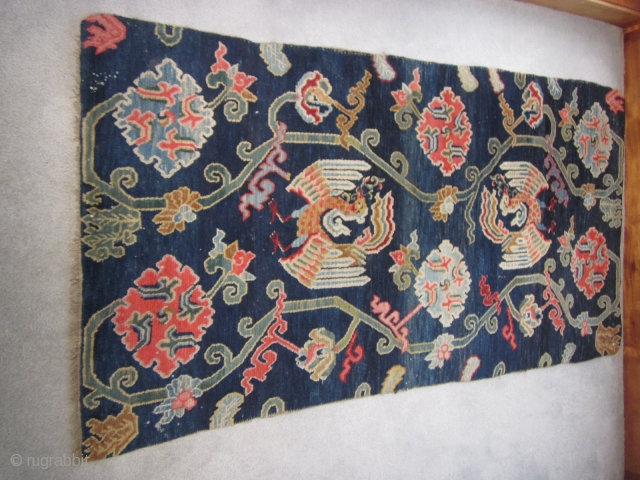 Tibetan khaden, floral elements, including lotuses, and two phoenixes (that look like peacocks!) on indigo ground, c.1930, 2'11" by 5'6" $700            