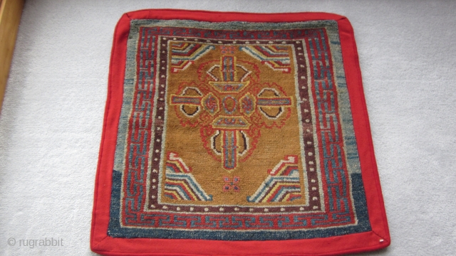 Tibetan sitting mat with eccentric double dorjee, 30 by 30 inches.Village weaving, probably before 1900.                  