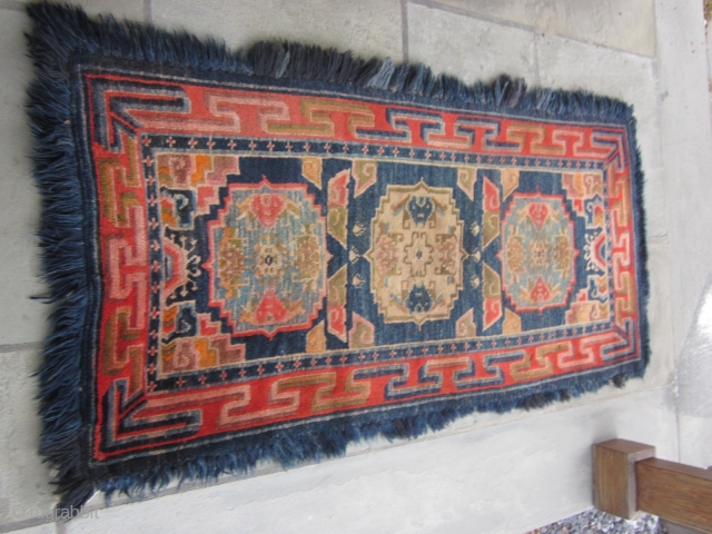 Tibetan long three "gul" khaden with blue fuzzy border, post-1900, 32 by 64 inches, excellent condition.                 