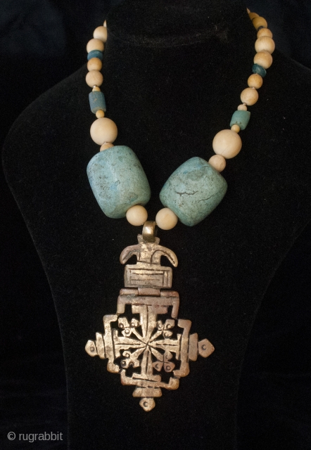 Old bronze Lalibela Coptic Cross from Ethiopia pendant insered on big old amazonite beads from Sahara, contemporary ivory and blue dutch. 

Cross Size: 9 cm x  6 CM

diameter of beads: 3  ...