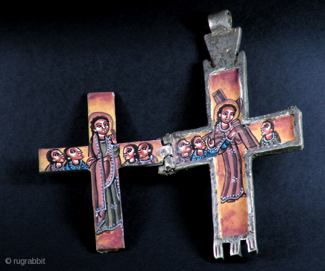 OLD COPTIC CROSS WITH ICON INSIDE

Old big silver metal Coptic cross amulet with painted icon inside. From Ethiopia

SIZE: 13 cm x 7 cm          