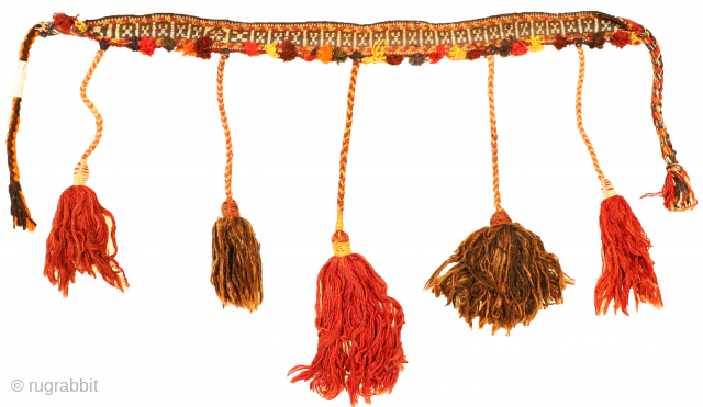 This antique band of the Qashqai tribe was woven from wool woven with natural dyes. The wool is finely spun, which allows a small and meticulous design to be made. The pompoms  ...