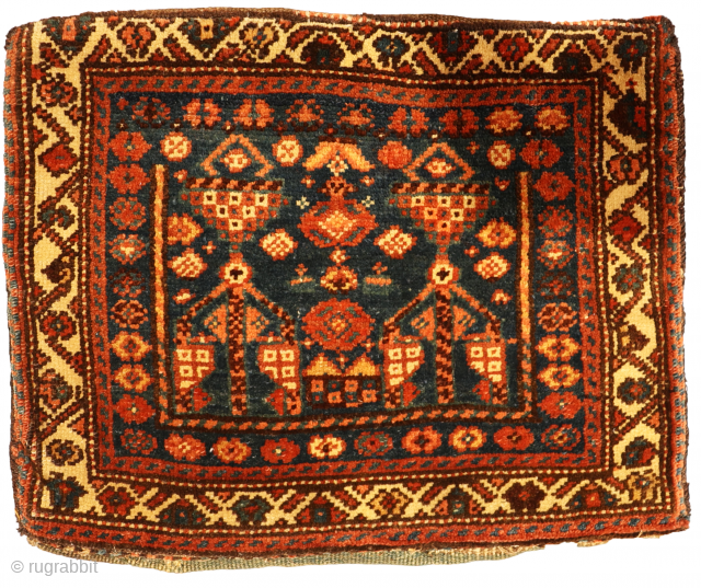 This antique chanteh or bag from the Qashqai tribe of Iran has a very unusual design. All dyes are natural. On the back of the kilim there is some staining.

You can buy  ...