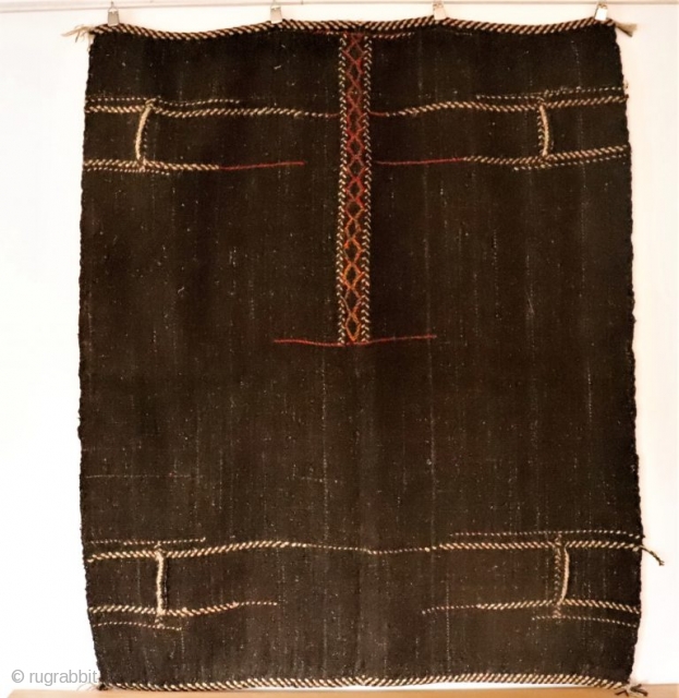 Originally this kilim was a large Qashqai camel bag that has been opened out to make a kilim. It is woven with undyed black goat´s hair and for the dyed areas sheep´s  ...