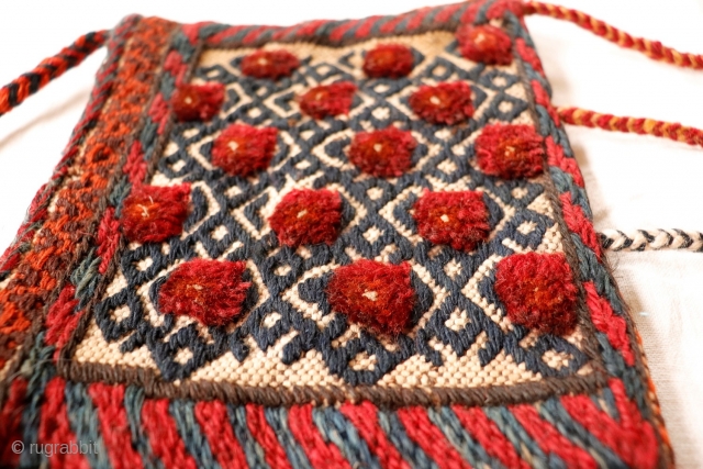 Cute small little bag woven by Bakhtiri nomads from Iran. It combines kilim and knotted areas. Both sides of the bag are worked (back and front). All natural dyes except for the  ...