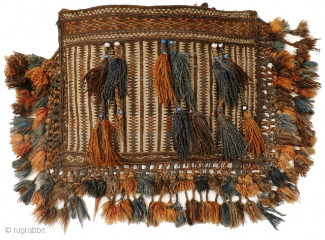 This chantah or bag is finely woven with the kilim technique and profusely decorated with a multitude of pompoms, and blue and white beads (protection against the evil eye). In perfect state  ...