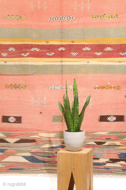 This antique Balikesir kilim features a rare and distinctive design, reminiscent of some early 1800s Balikesir Yuncu kilims. The central field is adorned with enigmatic motifs, seemingly depicting small, intricate rugs. The  ...