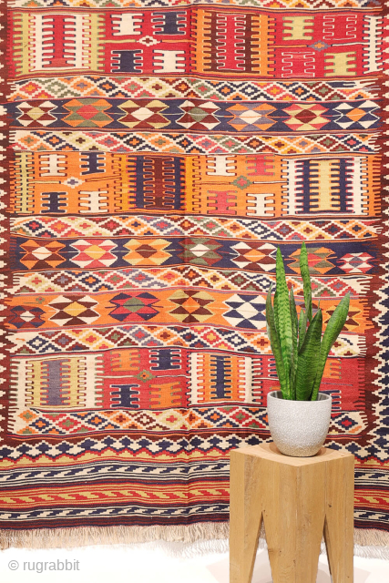 This  Qashqai kilim features a horizontal layout made up of bands of varying widths. Within these bands, the weaver incorporated a variety of traditional motifs — most notably the “comb” motif,  ...