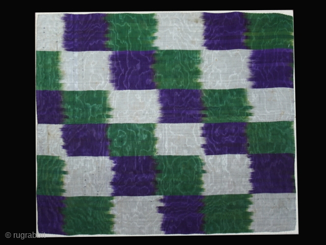 Ikat fragment cod. 0212.Silk. Uzbekistan. Central Asia. Circa 1900's. Very good condition. Cm. 42 x 50 (1'5" x 1'8"). Sewn onto a cotton textile and mounted on a wooden frame.   