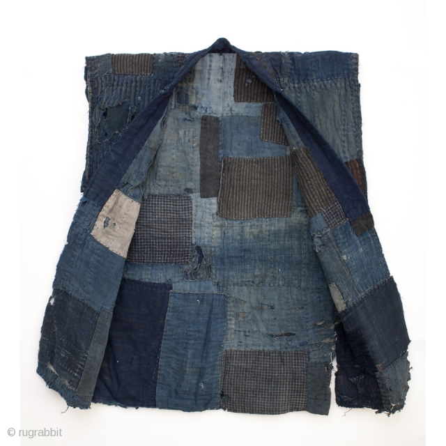 This is a boro sodenashi, or sleeveless jacket. This garment is part of a Japanese farmer's work wear and is well worn, carefully patched, and mended. It's ground is comprised of beautiful  ...