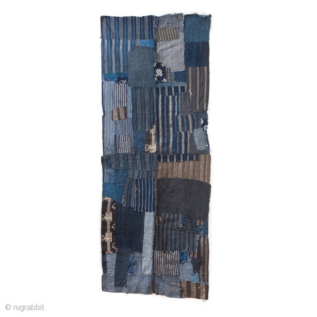 This is a large, heavily patched fragment of a Japanese boro futon cover. There are over sixty pieces of cloth on this textile, which have been sashiko stitched on top of one  ...