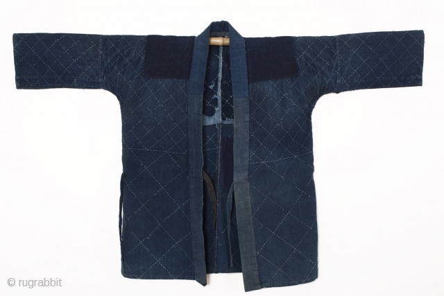 This is cotton noragi or Japanese worker's jacket. Made entirely of indigo, this noragi's hand-stitched sashiko design is a simple and geometric diamond pattern. From the characters sewn to the inside of  ...